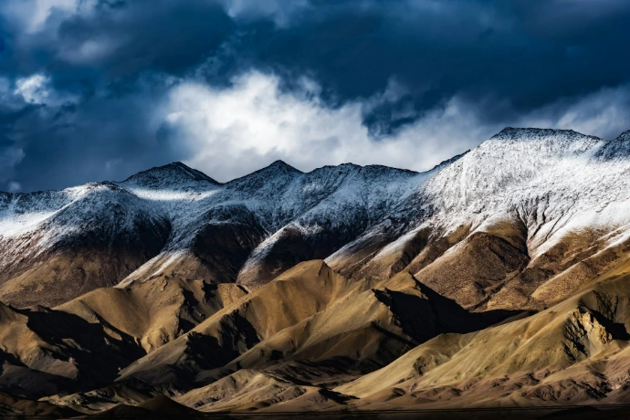 a mountain range with clouds